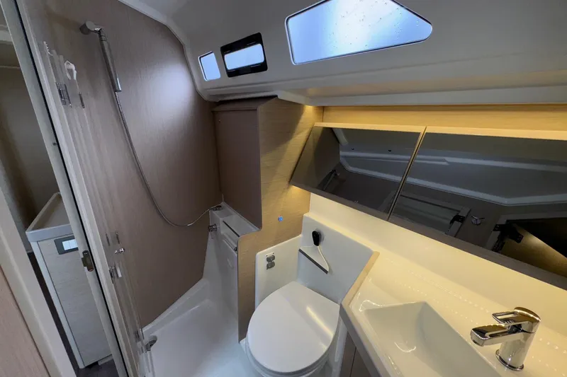 Slide: The Image of Modern bathroom interior of 2022 Beneteau Oceanis 40.1 yacht, featuring sleek fixtures and ample lighting. - 44