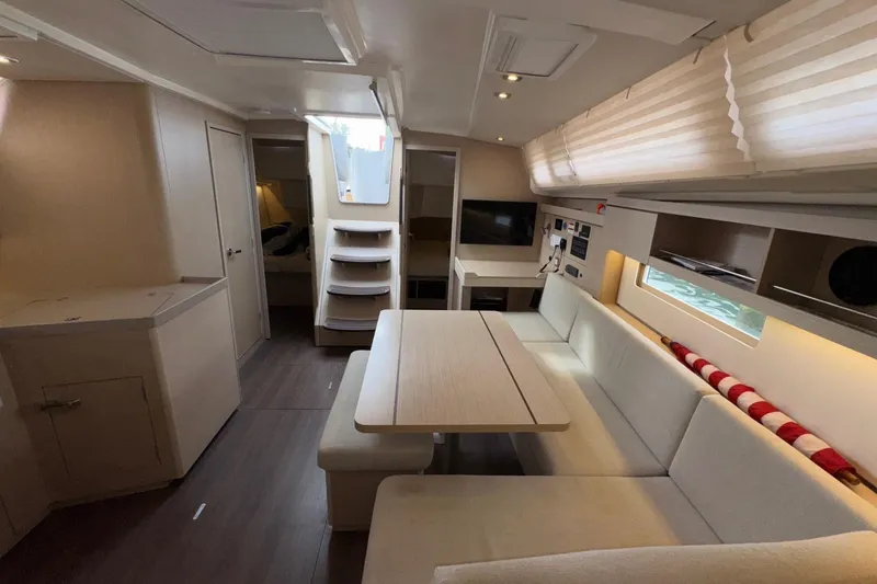 Slide: The Image of Interior of 2022 Beneteau Oceanis 40.1 yacht, featuring modern seating and dining area. - 25
