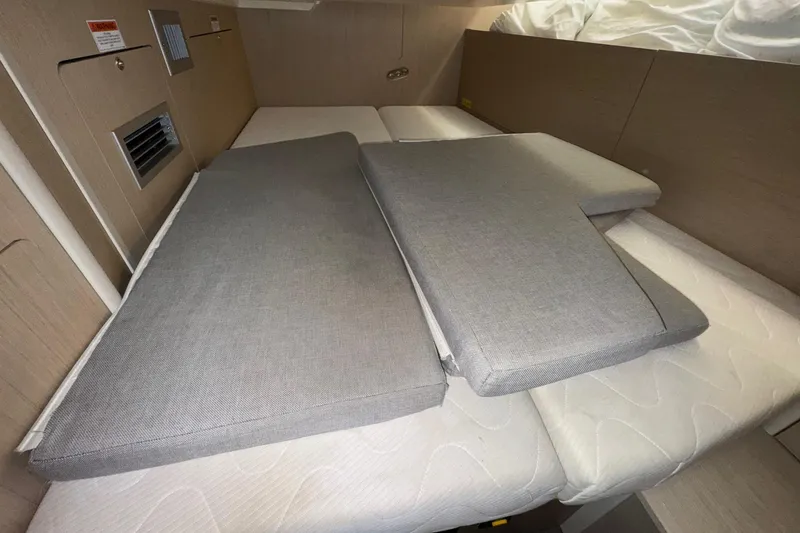 Slide: The Image of Interior cabin of 2022 Beneteau Oceanis 40.1 yacht with cushions on bed. - 41