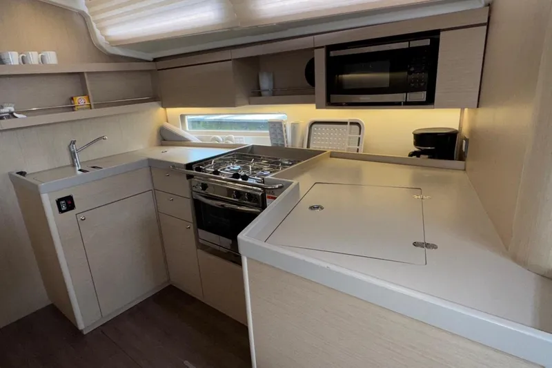 Slide: The Image of Modern kitchen interior of 2022 Beneteau Oceanis 40.1 yacht with stove and microwave. - 32