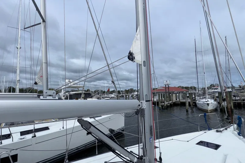 Slide: The Image of 2022 Beneteau Oceanis 40.1 sailboat docked at a marina under cloudy skies. - 17