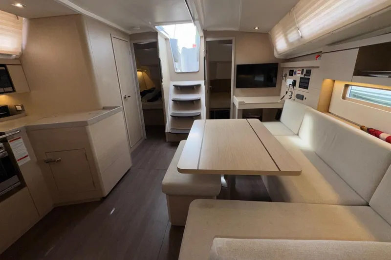 Slide: The Image of Interior of 2022 Beneteau Oceanis 40.1 yacht, featuring modern dining area and kitchen. - 34
