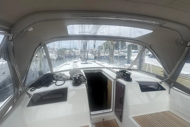 Slide: The Image of Interior view of 2022 Beneteau Oceanis 40.1 sailboat cockpit with marina background. - 22