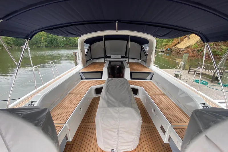 Slide: The Image of 2019 Beneteau Oceanis 51.1 sailboat cockpit with teak decking and navy canopy. - 1