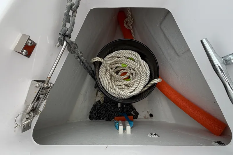 Slide: The Image of Anchor storage compartment on 2023 Axopar 28 Cabin boat with rope and chain. - 39