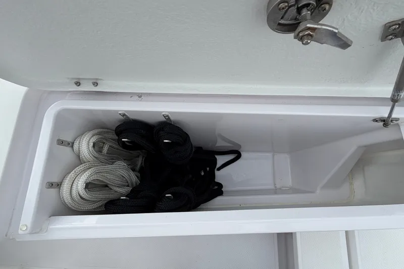 Slide: The Image of Storage compartment with ropes on a 2023 Axopar 28 Cabin boat. - 44
