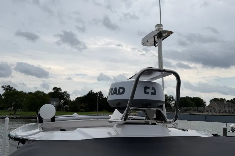 Slide: The Image of 2023 Axopar 28 Cabin boat with radar equipment, under cloudy sky. - 50