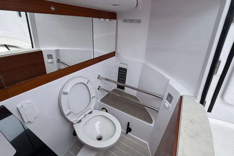 Slide: The Image of 2023 Axopar 28 Cabin bathroom with modern fixtures and sleek design. - 28