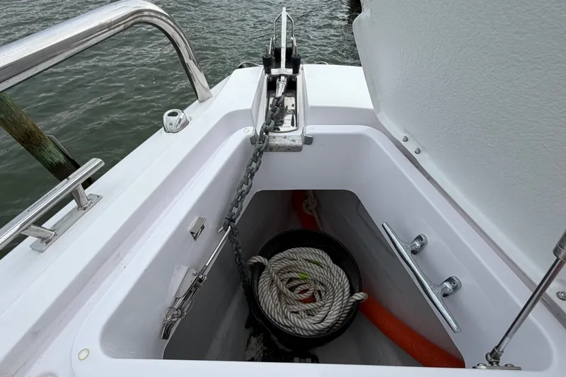 Slide: The Image of Anchor compartment of 2023 Axopar 28 Cabin boat with rope and chain. - 38