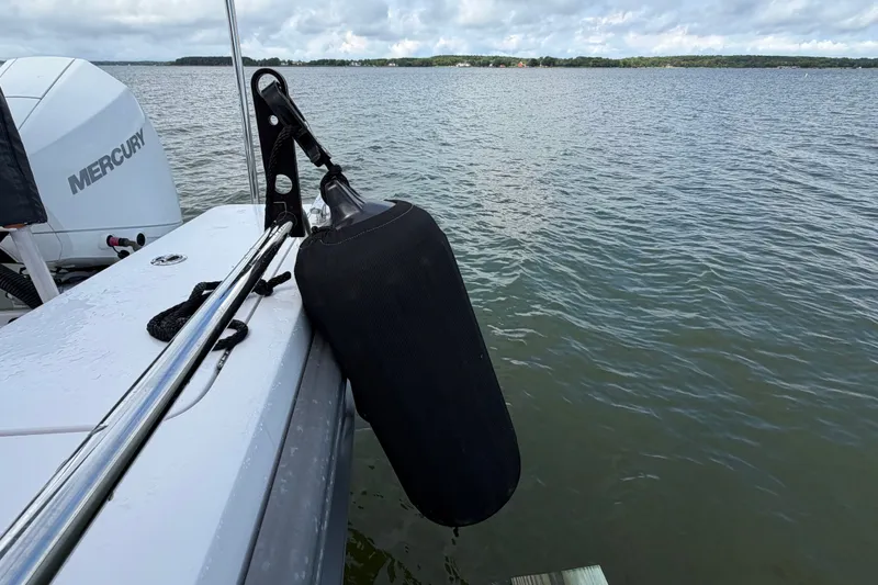 Slide: The Image of 2023 Axopar 28 Cabin boat with Mercury engine on calm water. - 54