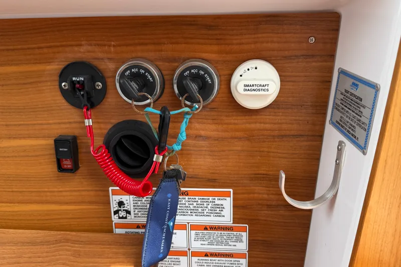 Slide: The Image of Control panel of 2023 Axopar 28 Cabin with switches and diagnostic tools. - 14