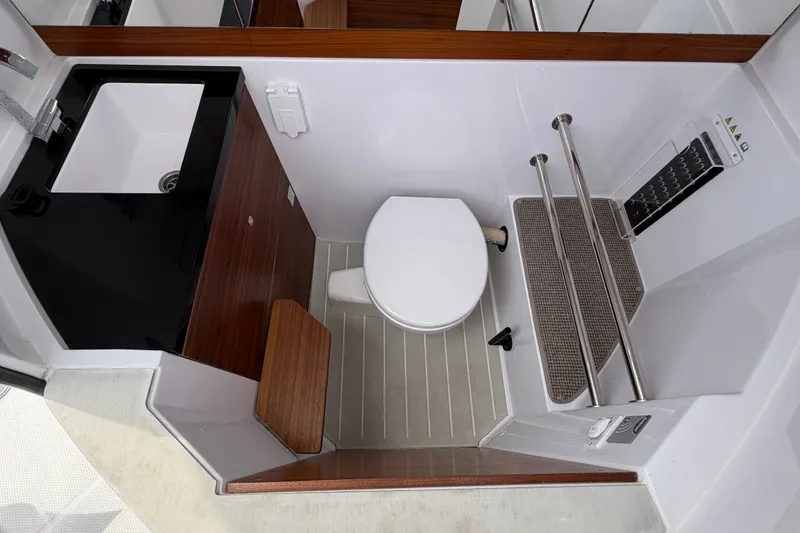 Slide: The Image of 2023 Axopar 28 Cabin bathroom with modern sink and toilet design. - 27