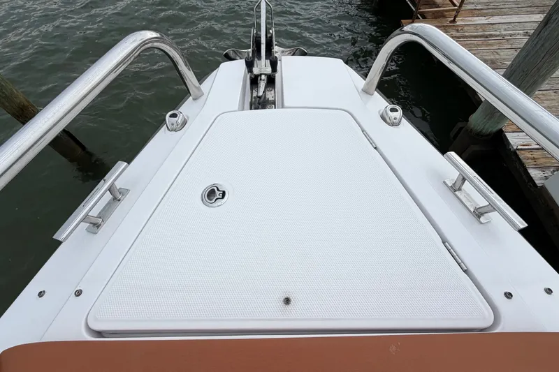 Slide: The Image of Bow view of 2023 Axopar 28 Cabin boat, featuring sleek design and stainless steel railings. - 36