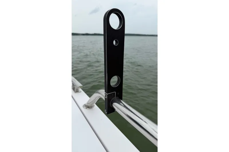 Slide: The Image of Close-up of a 2023 Axopar 28 Cabin boat railing with a black bracket. - 52