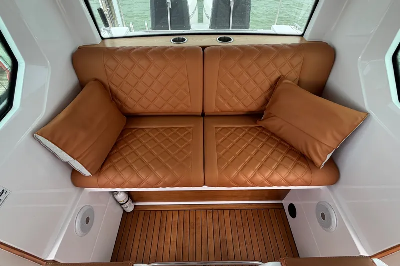 Slide: The Image of Luxurious leather seating in 2023 Axopar 28 Cabin boat interior, featuring elegant diamond stitching. - 16