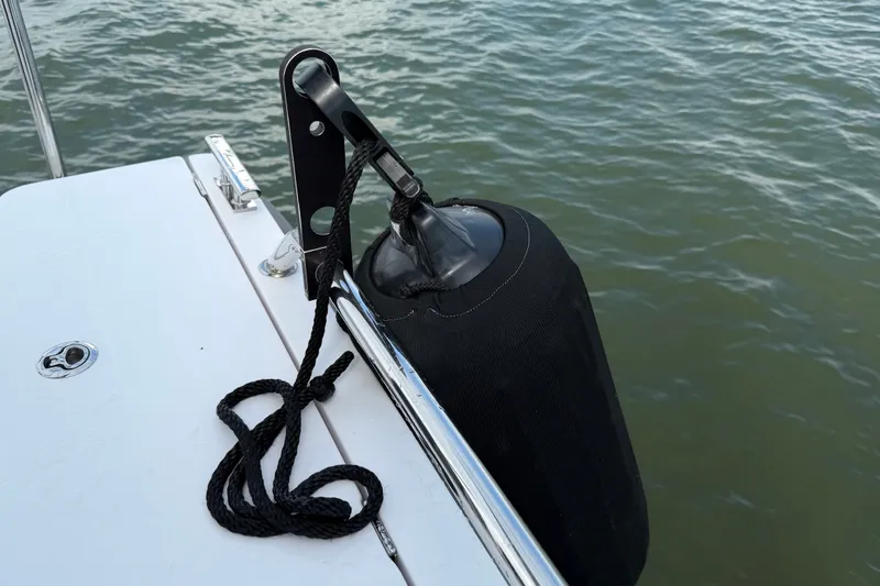 Slide: The Image of Boat fender secured on 2023 Axopar 28 Cabin, floating on water. - 53