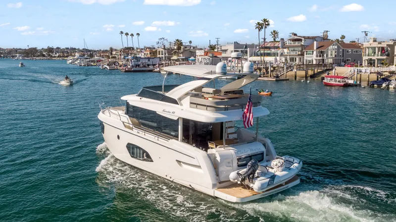 Slide: The Image of Die Absolute Navetta 48 von 2020 fährt durch einen belebten Hafen mit mehreren anderen Booten. - 5