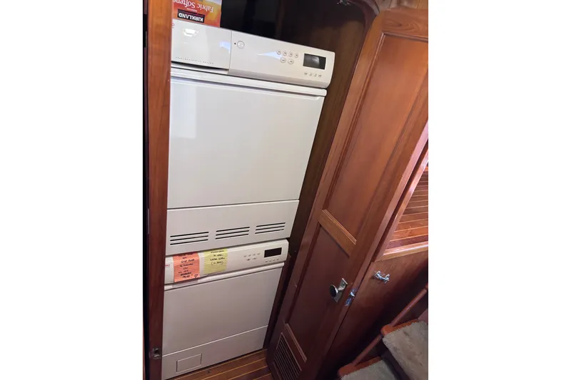 Slide: The Image of Laundry area inside 1991 Kha Shing Motoryacht with stacked washer and dryer. - 42