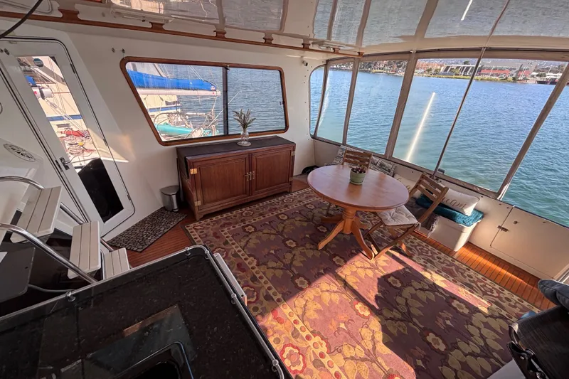 Slide: The Image of Interior of 1991 Kha Shing Motoryacht with elegant seating and waterfront view. - 15