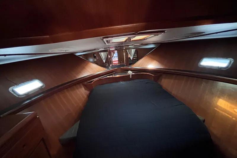 Slide: The Image of Luxurious 1991 Kha Shing Motoryacht cabin interior with cozy bed and wooden finish. - 27