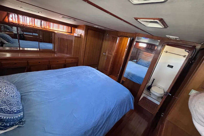Slide: The Image of Luxurious 1991 Kha Shing Motoryacht bedroom with wooden interior and ensuite bathroom. - 45