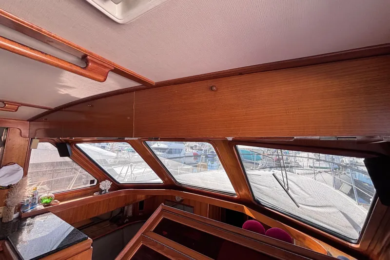 Slide: The Image of Interior view of 1991 Kha Shing Motoryacht with wooden paneling and large windows. - 57