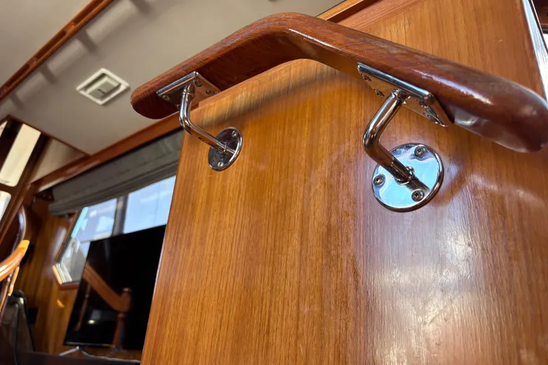 Slide: The Image of Wooden interior detail of a 1991 Kha Shing Motoryacht, featuring polished metal fittings. - 28