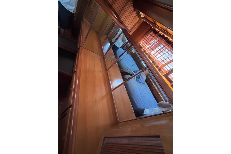 Slide: The Image of Interior of 1991 Kha Shing Motoryacht with wooden cabinetry and mirrored surfaces. - 52