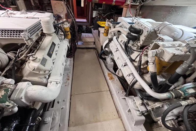 Slide: The Image of Engine room of a 1991 Kha Shing Motoryacht, showcasing dual engines and mechanical components. - 34
