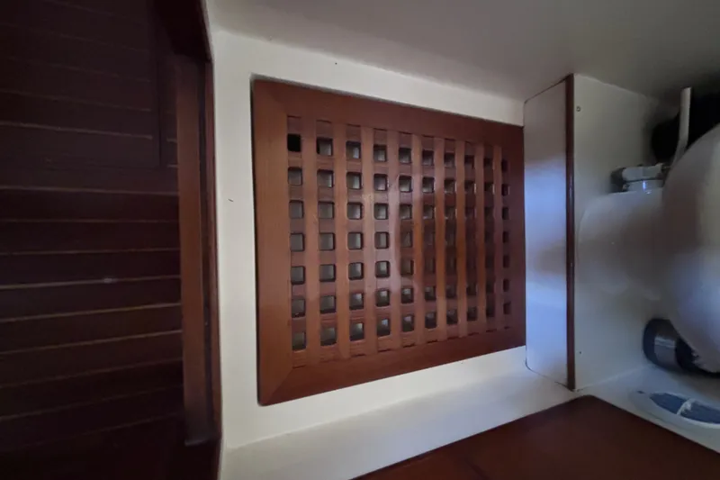 Slide: The Image of Wooden grate floor in a yacht cabin with white walls and wooden elements. - 49