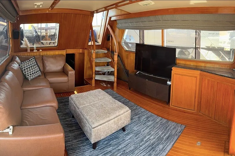 Slide: The Image of Luxurious 1991 Kha Shing Motoryacht interior with leather seating, TV, and wooden accents. - 58
