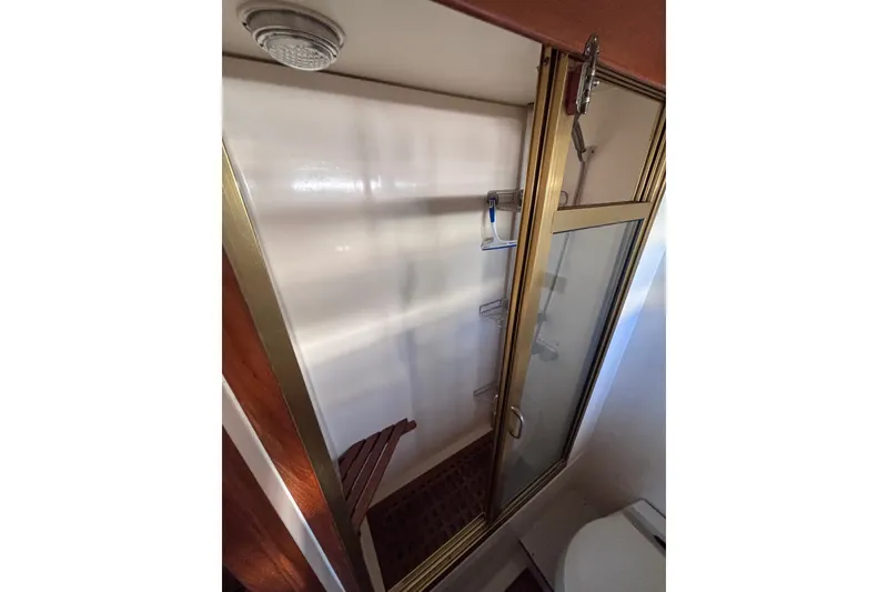 Slide: The Image of Shower area in 1991 Kha Shing Motoryacht with glass door and wooden accents. - 47