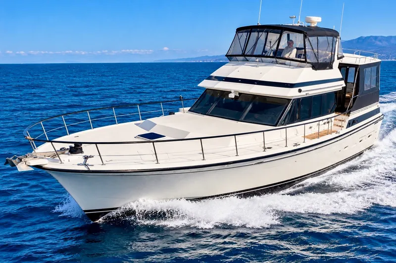 The Image of 1991 Kha Shing Motoryacht cruising on open sea under clear blue sky. - 0