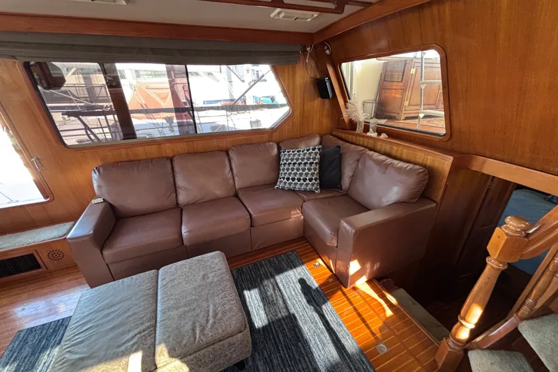 Slide: The Image of Luxurious 1991 Kha Shing Motoryacht interior with leather sofa and wooden accents. - 17