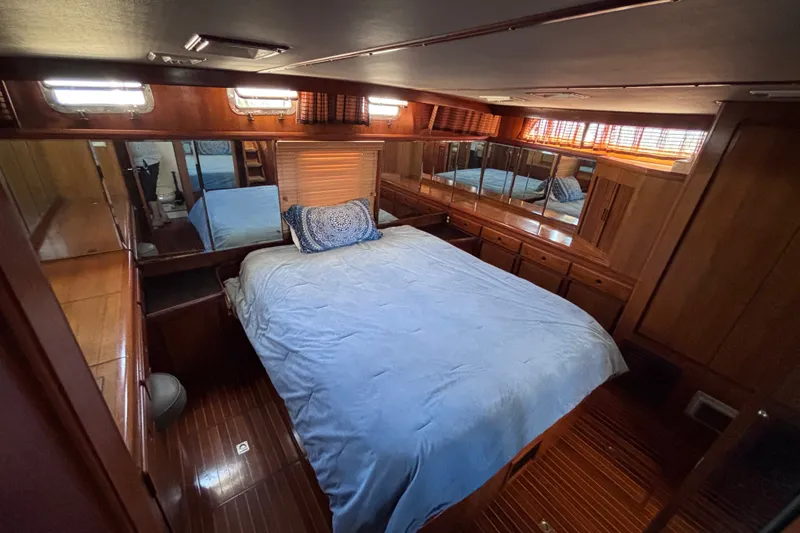 Slide: The Image of Luxurious 1991 Kha Shing Motoryacht bedroom with wooden interior and cozy bedding. - 44