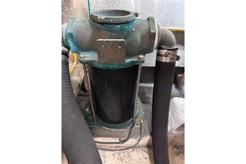 Slide: The Image of Engine component of a 1991 Kha Shing Motoryacht, featuring hoses and metal fittings. - 39