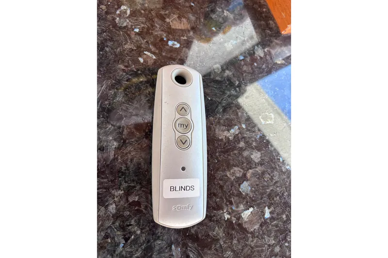 Slide: The Image of Remote control for blinds on a Kha Shing 1991 Motoryacht, placed on a marble surface. - 53
