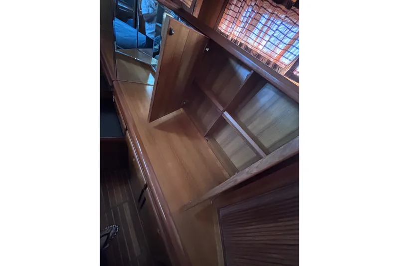 Slide: The Image of Interior of 1991 Kha Shing Motoryacht with wooden cabinetry and mirrored surfaces. - 51