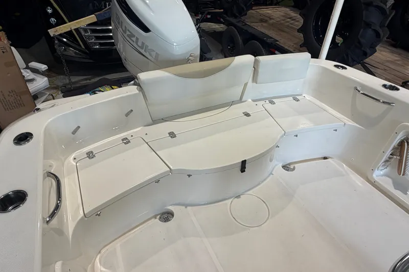 Slide: The Image of 2021 Bulls Bay 230 Center Console boat interior with Suzuki engine, featuring spacious seating and storage. - 12