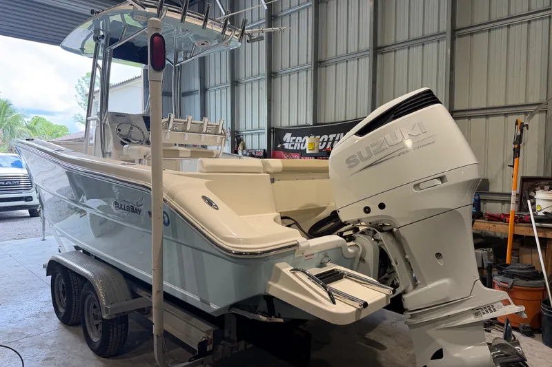 Slide: The Image of 2021 Bulls Bay 230 Center Console boat with Suzuki engine in a garage setting. - 15
