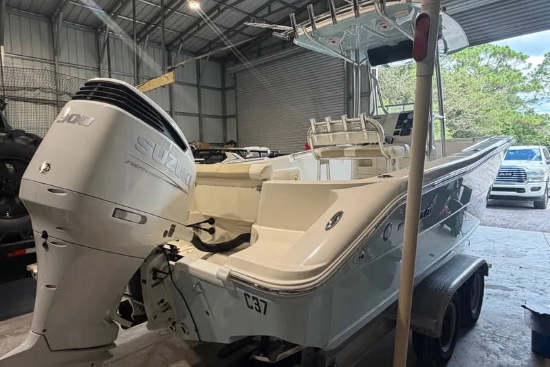 Slide: The Image of 2021 Bulls Bay 230 Center Console boat with Suzuki engine in a garage setting. - 14