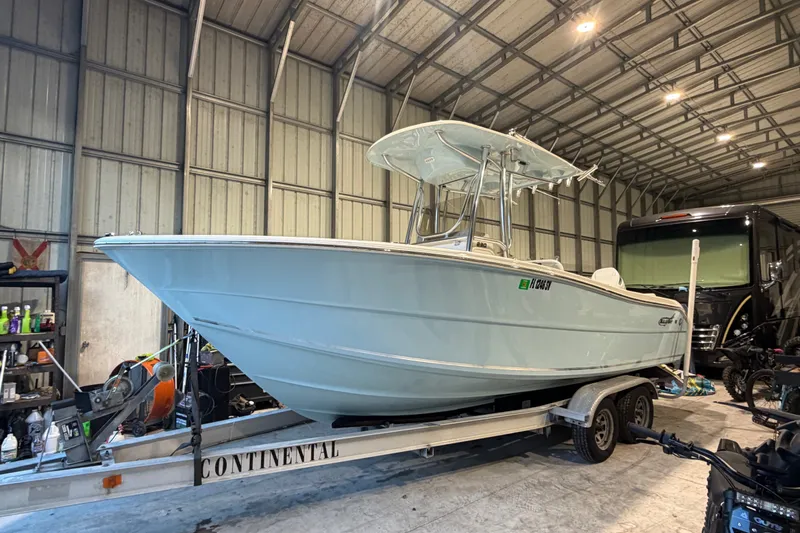 Slide: The Image of 2021 Bulls Bay 230 Center Console boat on trailer in a spacious garage. - 16