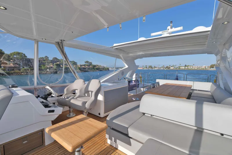 Slide: The Image of Luxurious 2018 Sunseeker 76 Yacht interior with seating, table, and scenic ocean view. - 41