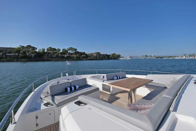 Slide: The Image of Luxurious 2018 Sunseeker 76 Yacht deck with elegant seating and scenic waterfront view. - 33