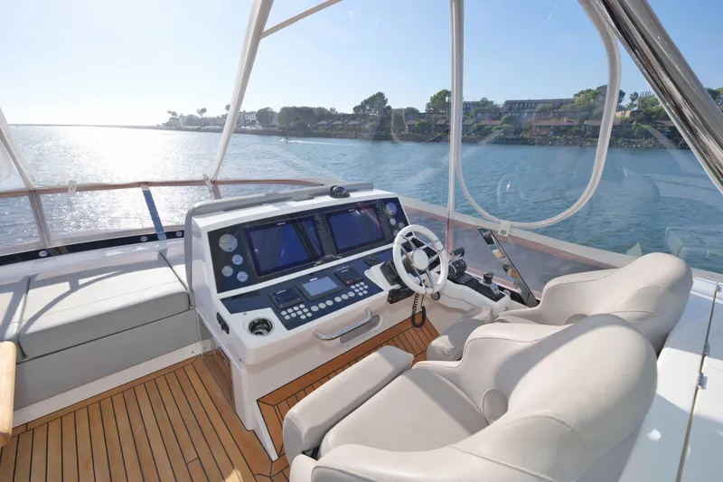 Slide: The Image of Luxurious helm of 2018 Sunseeker 76 Yacht with modern navigation equipment and scenic ocean view. - 39
