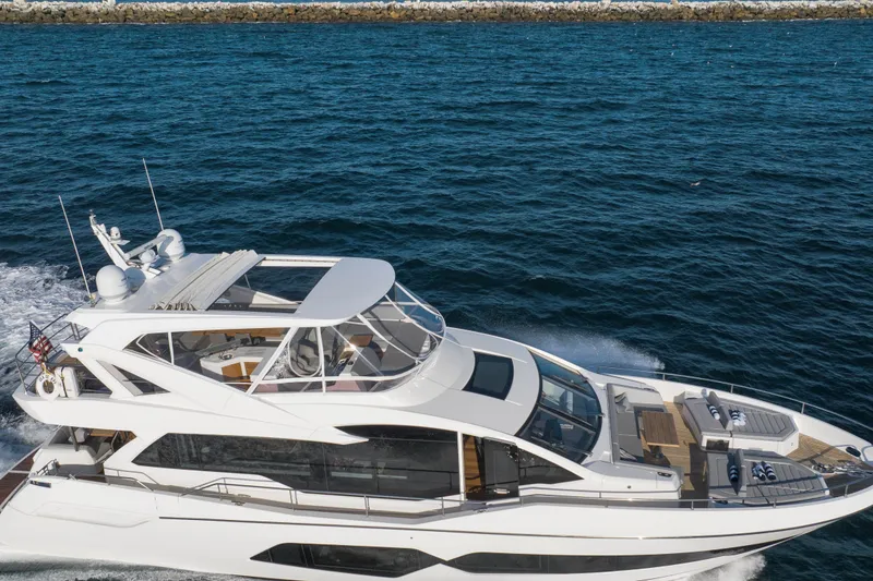 Slide: The Image of 2018 Sunseeker 76 Yacht cruising on open water, showcasing sleek design and luxury features. - 4