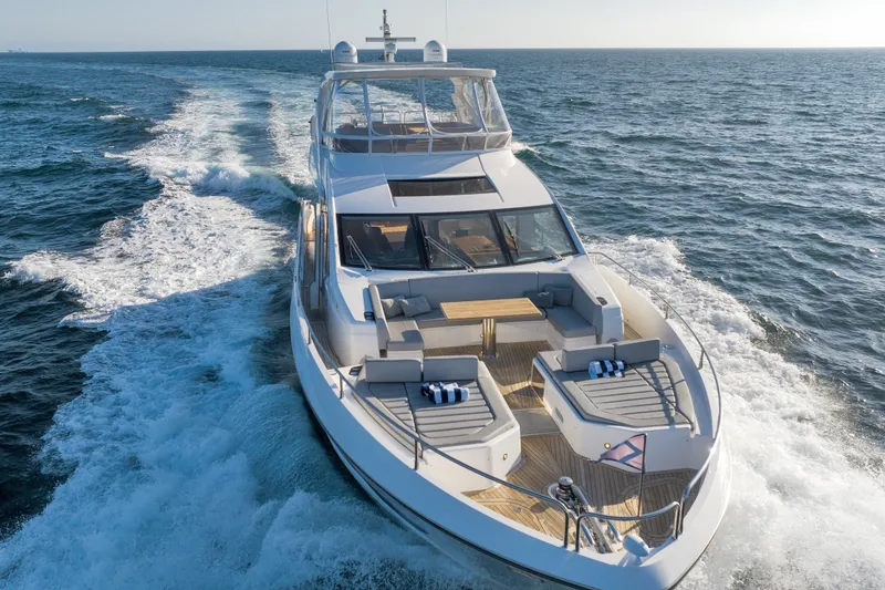 Slide: The Image of Luxurious 2018 Sunseeker 76 Yacht cruising on open sea, showcasing elegant design and spacious deck. - 7