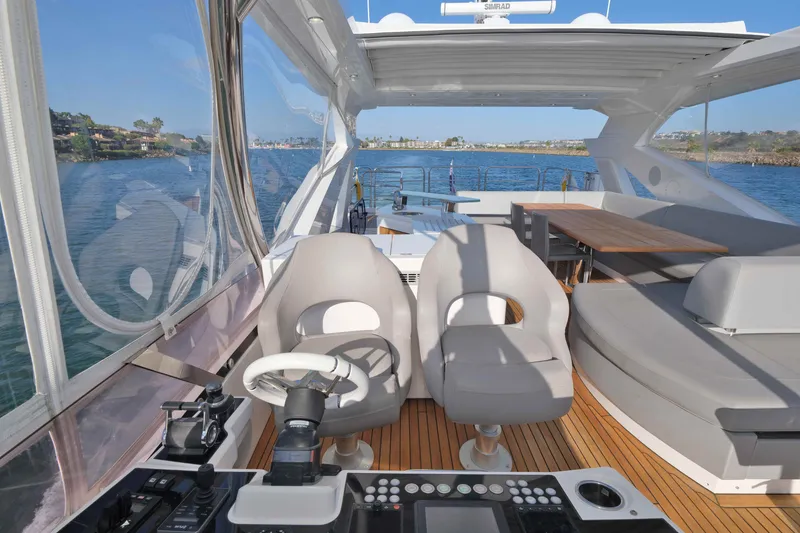 Slide: The Image of Cockpit view of 2018 Sunseeker 76 Yacht with luxurious seating and controls. - 42