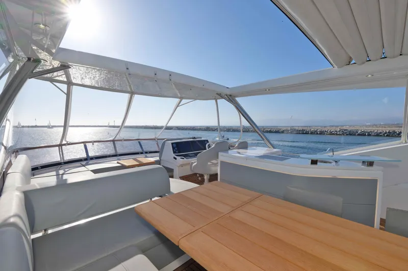 Slide: The Image of Luxurious 2018 Sunseeker 76 Yacht deck with seating, overlooking serene ocean view. - 46
