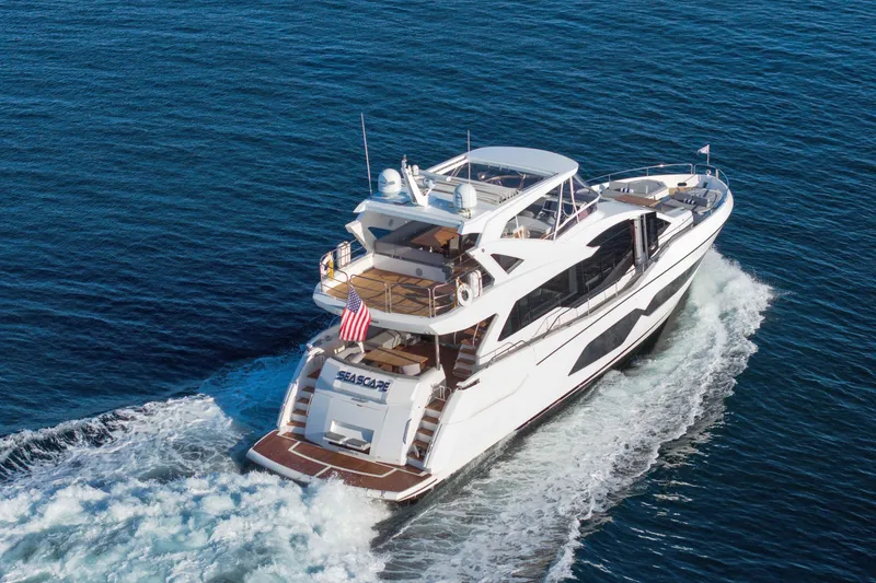 Slide: The Image of 2018 Sunseeker 76 Yacht cruising on open water, rear view. - 9